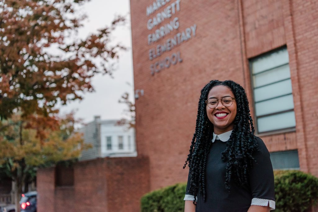 Photo of Lydia outside her elementary school teaching placement