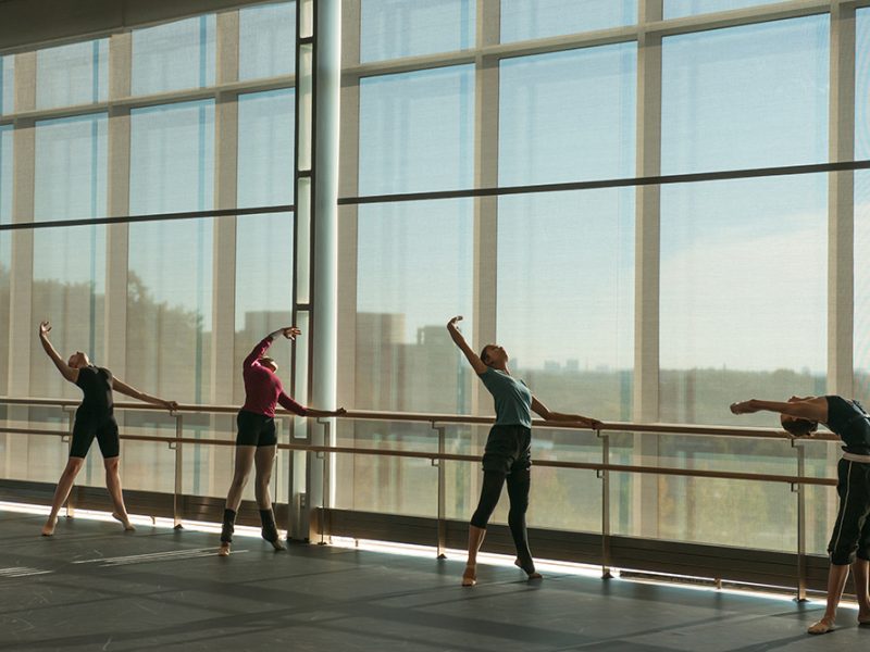 Four students at the barre in the UMBC dance cube