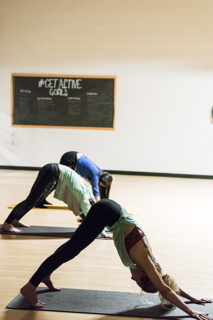 students doing yoga together